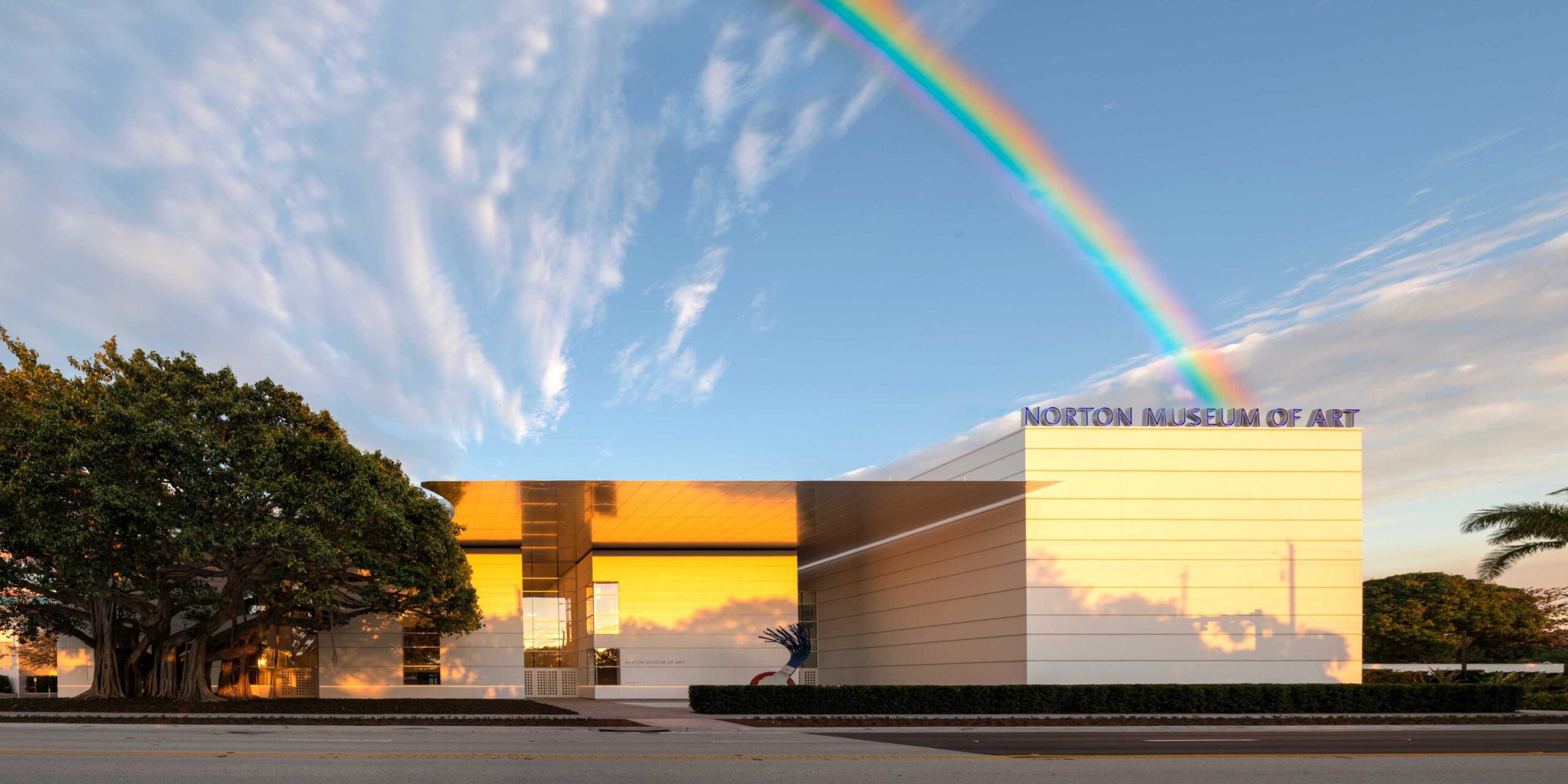 A picture of the Norton with a rainbow behind the building.